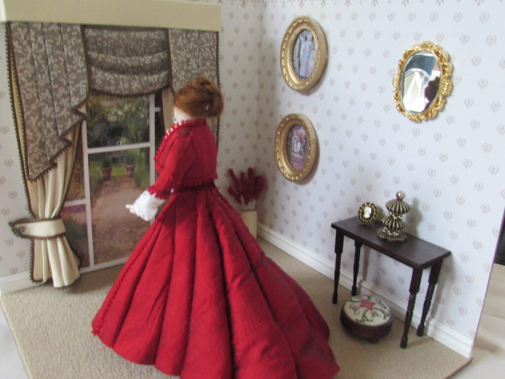 Doll's house doll in a red dress