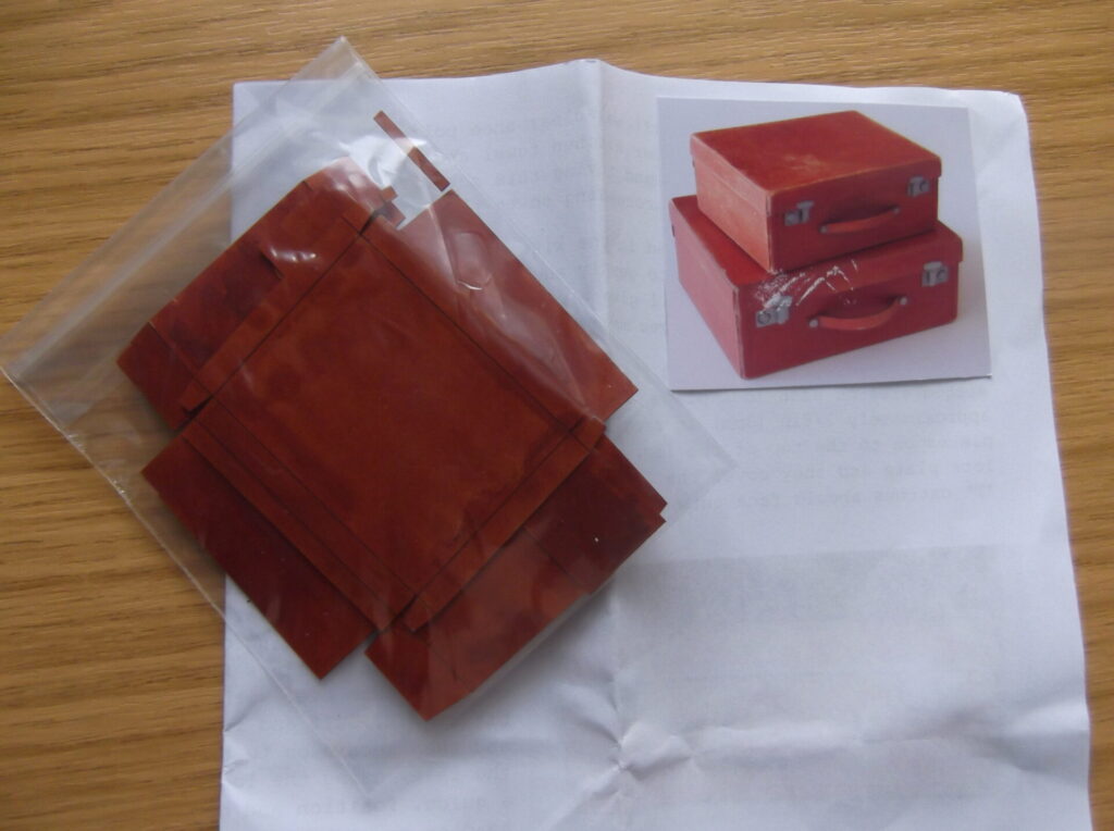 Doll's house red suitcases